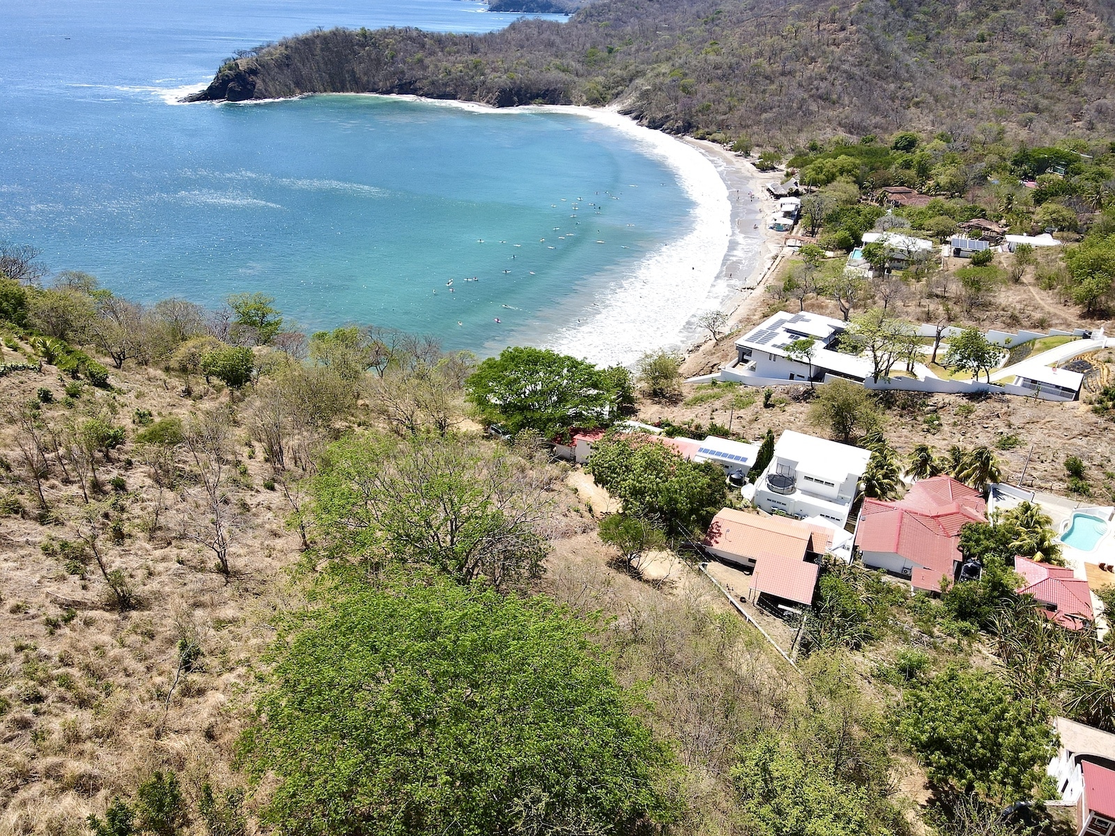 Surfers in the water at Playa Remanso